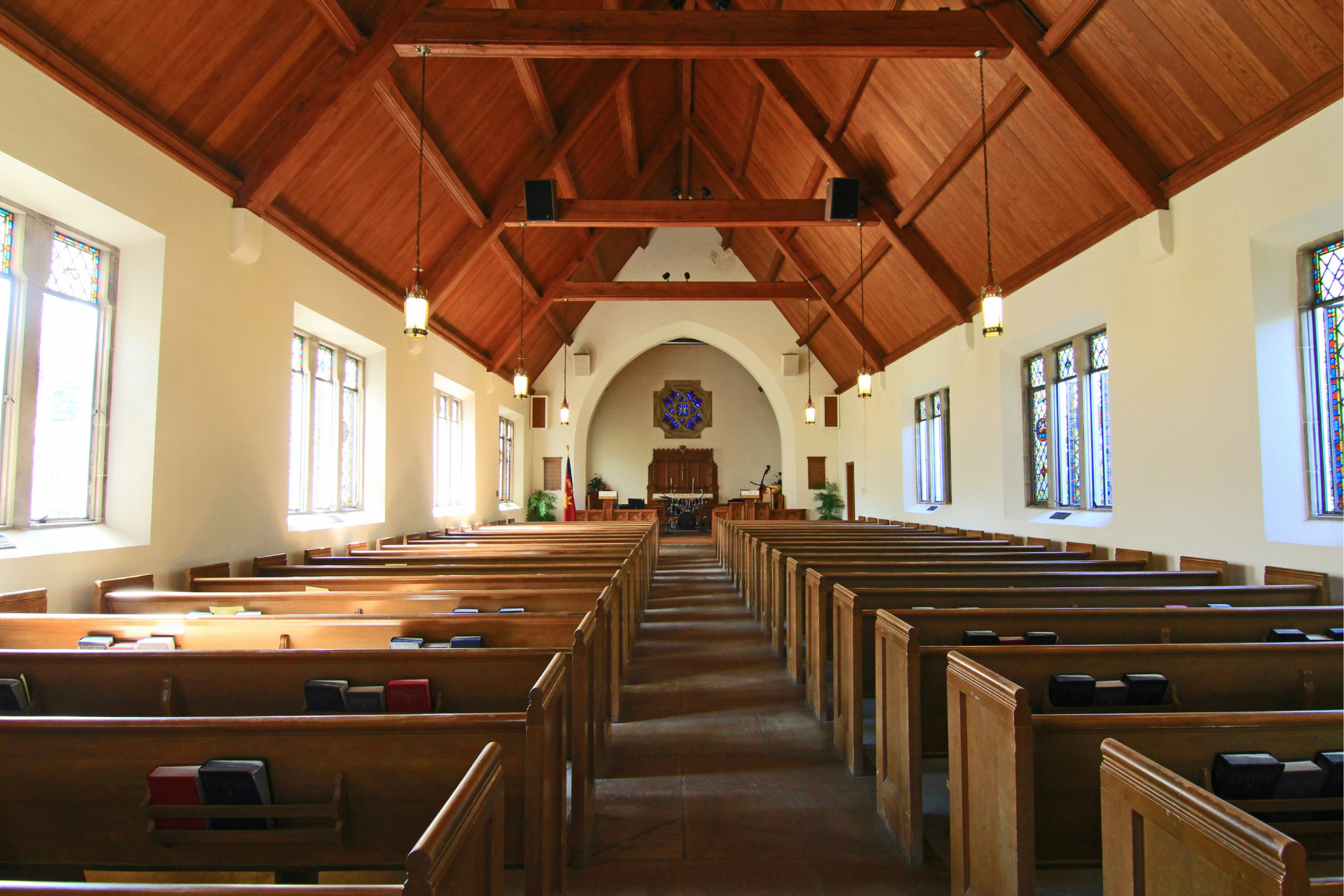 A Cathedrel in the on a warm day with light streaming in.